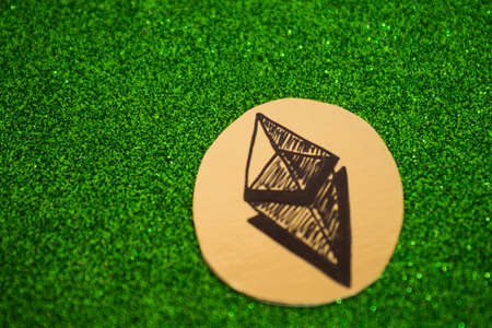 modern crypto currency on a green shiny backgroundの写真素材