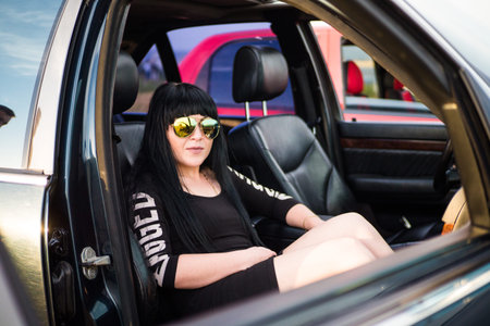 Brunette girl in the passenger seat of the car