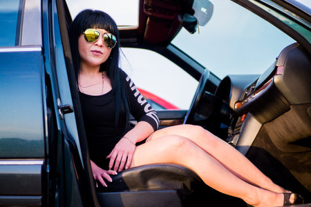 Brunette girl in the passenger seat of the car