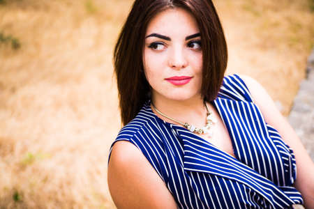 Brunette girl in blue long dress portraitの写真素材