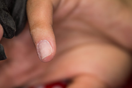 The master of nail extensions and coating with gel varnish makes correction to his client in the beauty salonの写真素材