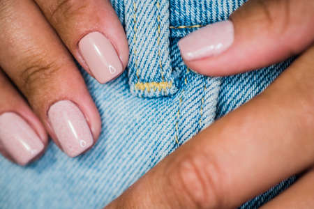 The master of nail extensions and coating with gel varnish makes correction to his client in the beauty salonの写真素材