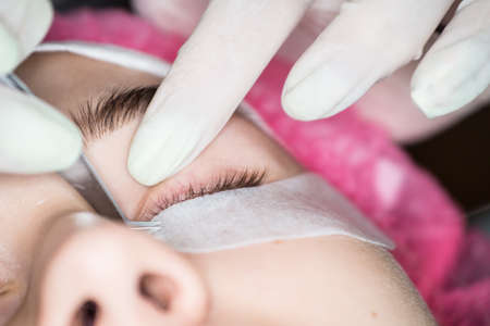 Specialist eyelashes in the beauty salon increases eyelashes clientの写真素材