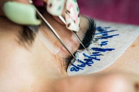 Specialist eyelashes in the beauty salon increases eyelashes clientの写真素材