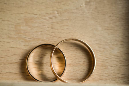 Golden wedding rings newlyweds close-upの写真素材