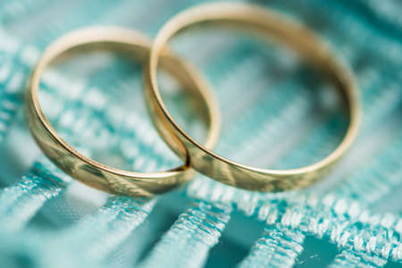 Golden wedding rings newlyweds close-upの写真素材