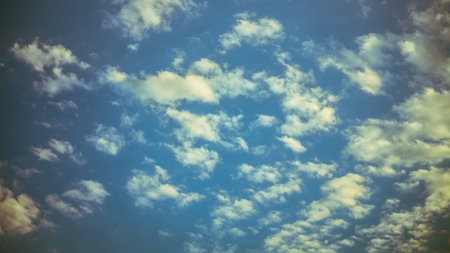 Large clouds float across the sunset sky like sails.