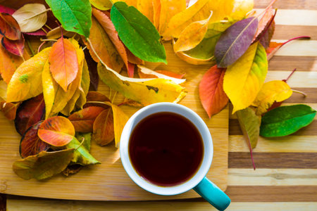 Hot flower tea in a blue mug on a wooden background.