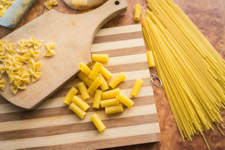 Different types of pasta Cellentani, Tortiglioni, Farfalle, spaghetti are often used in the kitchen for cooking.の写真素材