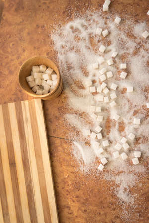 Sugar and refined sugar scattered on the table top view.の写真素材