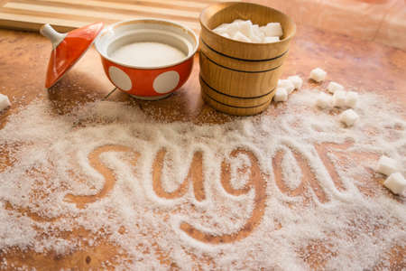 The inscription sugar on the table, refined sugar in a sugar bowl.の写真素材