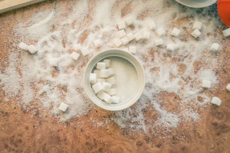 Sugar and refined sugar scattered on the table top view.の写真素材