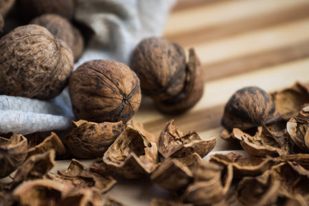 Peeled and shelled walnuts are scattered randomly on the table.