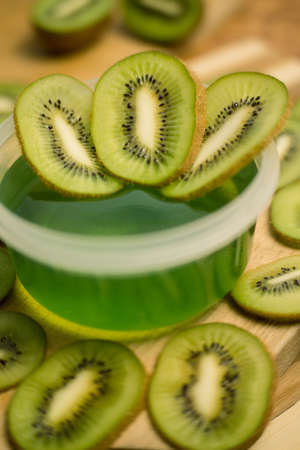 Jelly and kiwi cut into rings on a wooden backgroundの写真素材