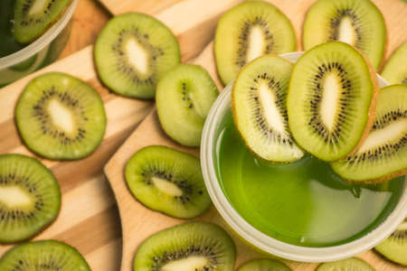 Jelly and kiwi cut into rings on a wooden backgroundの写真素材