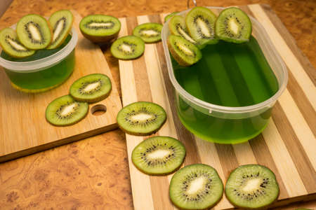 Jelly and kiwi cut into rings on a wooden backgroundの写真素材