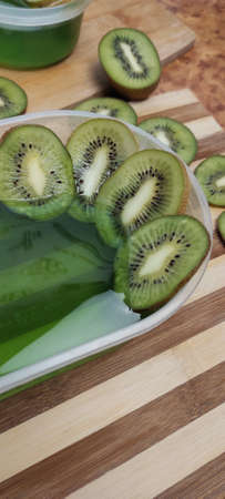 Jelly and kiwi cut into rings on a wooden backgroundの写真素材