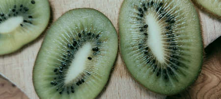 Jelly and kiwi cut into rings on a wooden backgroundの写真素材