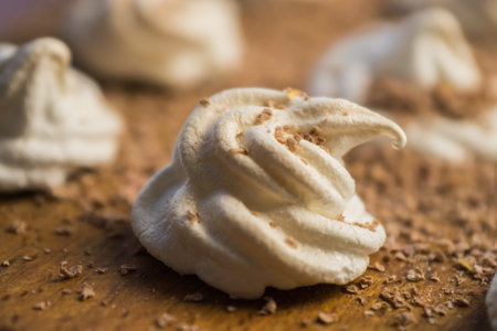 Delicious crispy homemade egg meringue sprinkled with grated dark chocolate, prepared with love on a...