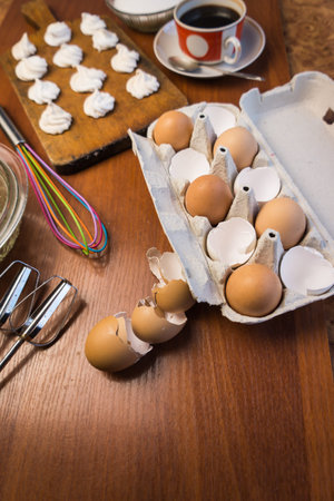 Delicious crispy homemade egg meringue, prepared with love on a wooden background, crunchy dessert...