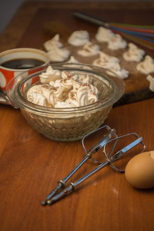 Delicious crispy homemade egg meringue sprinkled with grated dark chocolate, prepared with love on a...