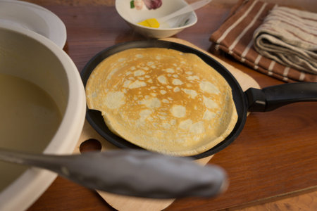 pancake week. Preparation of dough for baking delicious and ruddy pancakes from the ingredients eggs, flour, butter and milk. Maslenitsa traditional Russian festival meal.の写真素材