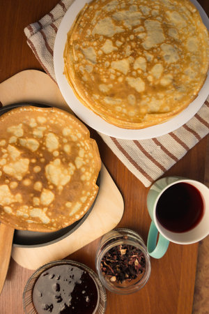 pancake week. Preparation of dough for baking delicious and ruddy pancakes from the ingredients eggs, flour, butter and milk. Maslenitsa traditional Russian festival meal.の写真素材