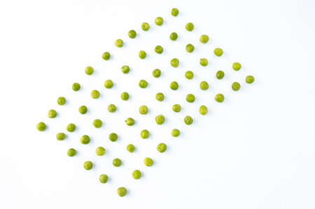flat lay of arranged green peas on white background の写真素材