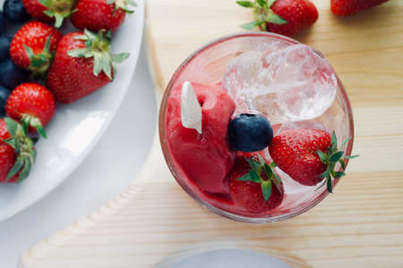 delicious tasty appetizing hand made ice cream with fruits with strawberry blueberry and ice, flatlay close upの写真素材