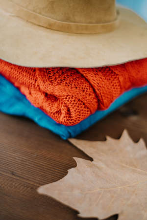 cozy autumn concept, warm autumn clothes and leaf over wooden nackground. Fall concept with warm colors の写真素材