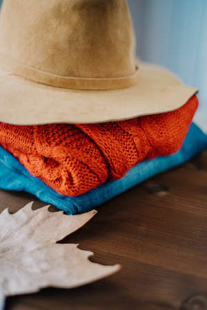 cozy autumn concept, warm autumn clothes and leaf over wooden nackground. Fall concept with warm colors の写真素材