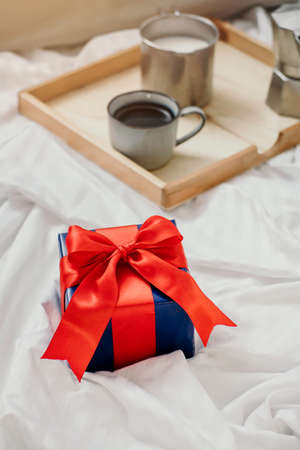 Romantic breakfast with coffee and milk served on tray and gift box valentine's day or holiday conceptの写真素材