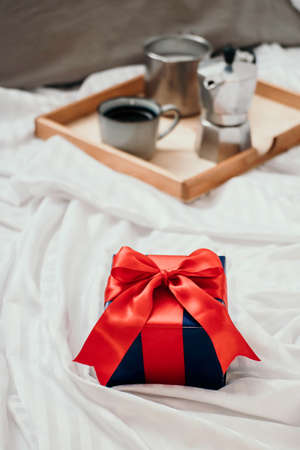 Romantic breakfast with coffee and milk served on tray and gift box valentine's day or holiday conceptの写真素材