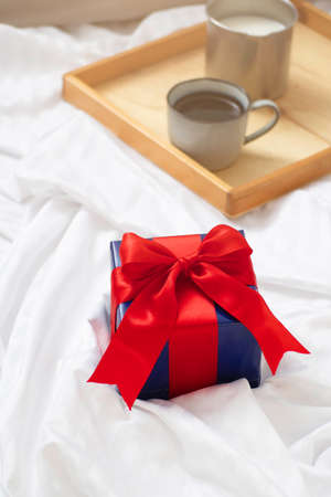 Romantic breakfast with coffee and milk served on tray and gift box valentine's day or holiday conceptの写真素材