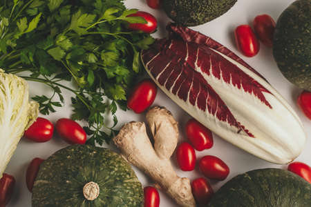 Fall seasonal vegetarian food ingredients variety. Flat lay of helthy vegetables on white background. Healthy organic vegetablesの写真素材