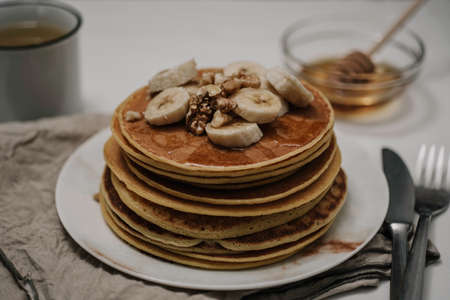 american traditional breakfast with pancakes bananas and nuts close upの写真素材