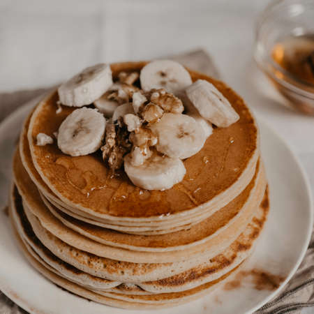 square crop american traditional breakfast with pancakes bananas and nuts close upの写真素材