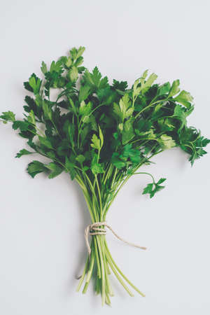 Flat-lay of bunches on white background. Healthy vegan cooking concept. Organic foodの写真素材