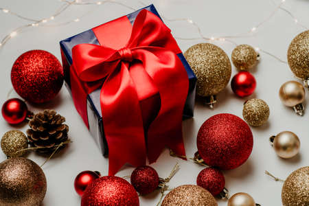 christmas decoration and christmas box gift present with red ribbon over white background. Golden and red christmas conceptの写真素材