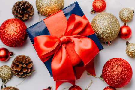 christmas decoration and christmas box gift present with red ribbon over white background. Golden and red christmas conceptの写真素材