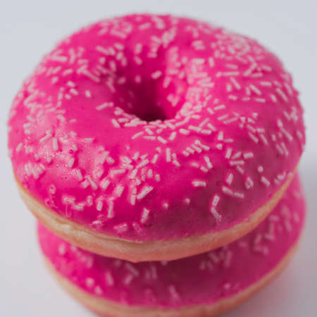 pink sweet glazed donuts on white backgroundの写真素材