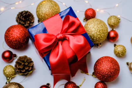 christmas decoration and christmas box gift present with red ribbon over white background. Golden and red christmas conceptの写真素材