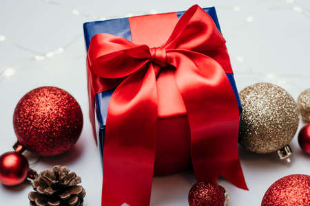 christmas decoration and christmas box gift present with red ribbon over white background. Golden and red christmas conceptの写真素材