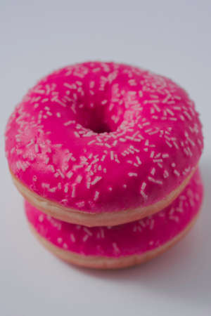 pink sweet glazed donuts on white backgroundの写真素材
