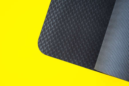 grey yoga mat over yellow background with copy space. Healthy lifestyle, meditation, active lifeの写真素材