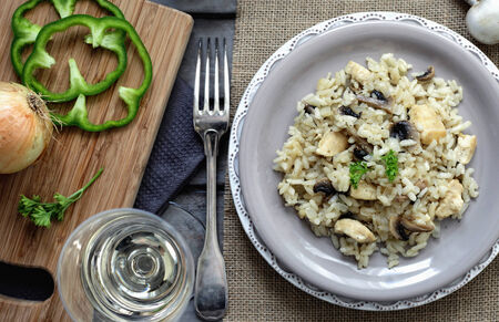 Risotto with chicken and mushrooms on a grey plateの写真素材