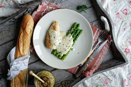 Chicken and asparagus on a white plateの写真素材