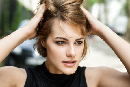 Girl brushing her hair through with fingers.の写真素材