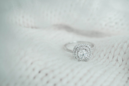 Close up diamond ring on white scarf background with vintage tone.(soft and selective focus)の写真素材