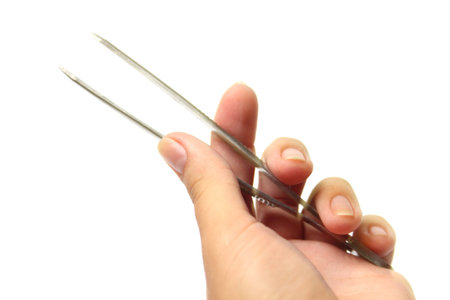 Tweezers in his hand isolated on white background